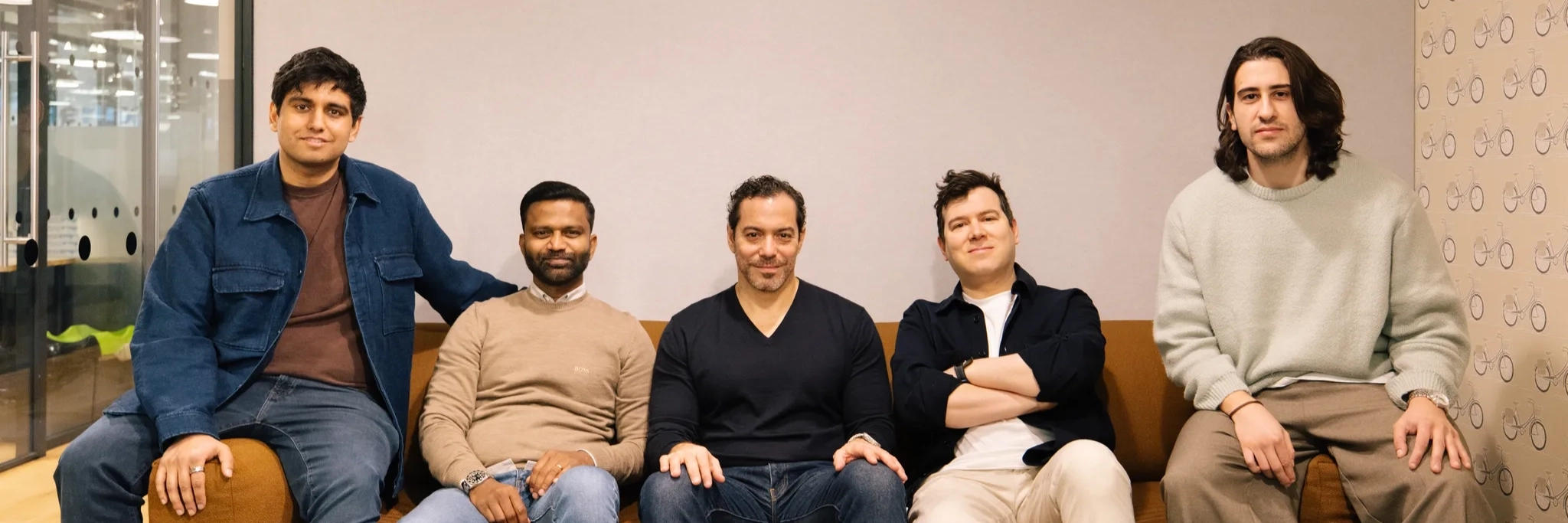 Members of the Paid team sitting in a couch.